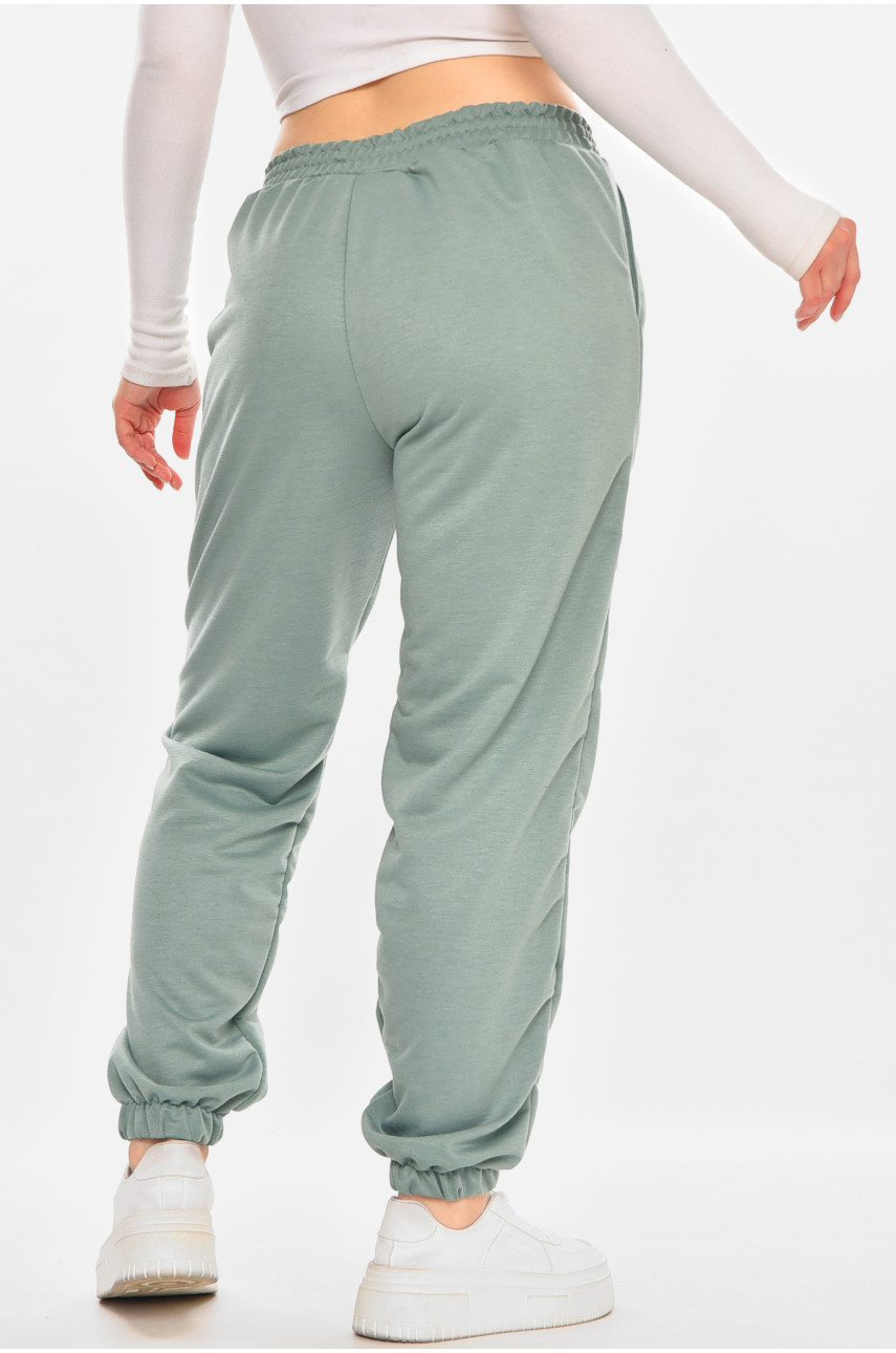 Спортивні штани жіночі напівбатальні однотонні зеленого кольору 212817